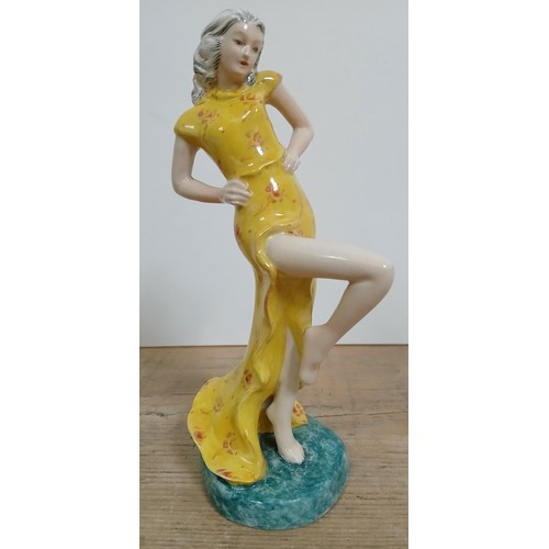 276 - A Goldscheider Art Deco figurine modelled as a lady in yellow dress, height 18cm.