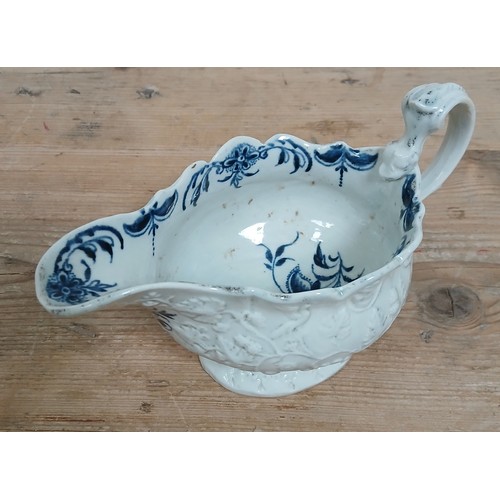 307 - An English relief moulded porcelain sauce boat, circa 1770, bluer and white decorated interior with ... 