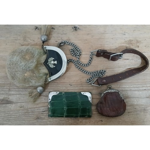 387 - A mixed lot comprising a child's sporran a silver mounted green leather wallet and another.