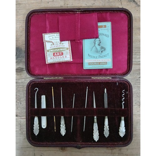 380 - A late Victorian red leather velvet lined cased sewing accoutrements set with mother of pearl handle... 