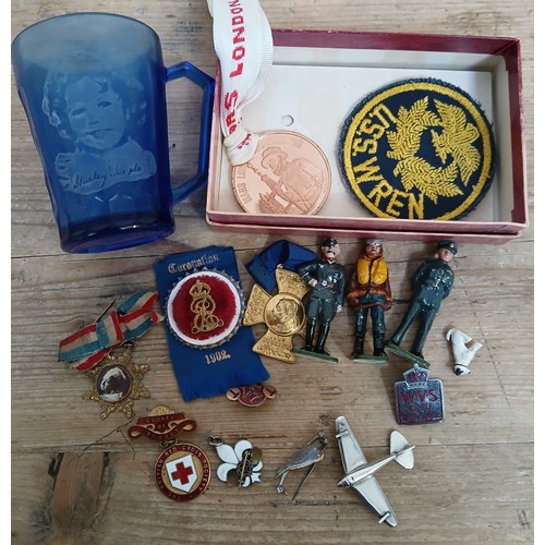 398 - Assorted collectables including a Shirley Temple blue glass mug, badges, medals, aeroplane brooch ma... 