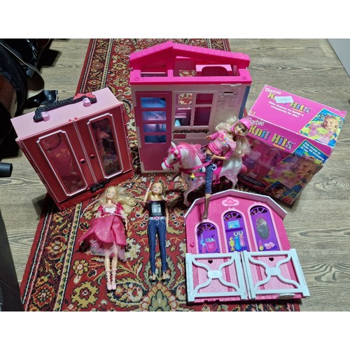 418 - A box of assorted Barbie toys to include a folding house with accessories, fashionista dolls wardrob... 