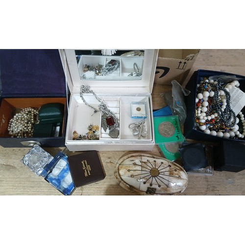 653 - A box of costume jewellery including watches, coins etc.