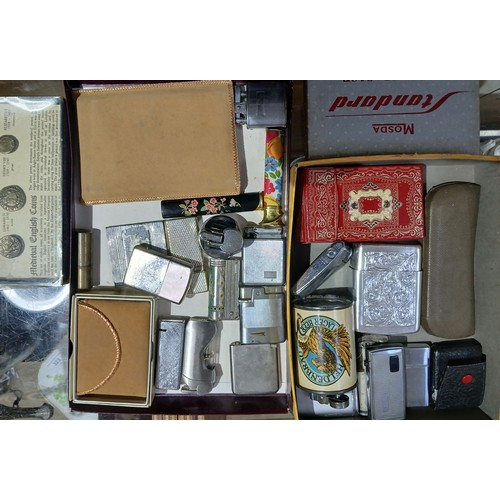 671 - Two trays of assorted vintage lighters and cigarette cases.