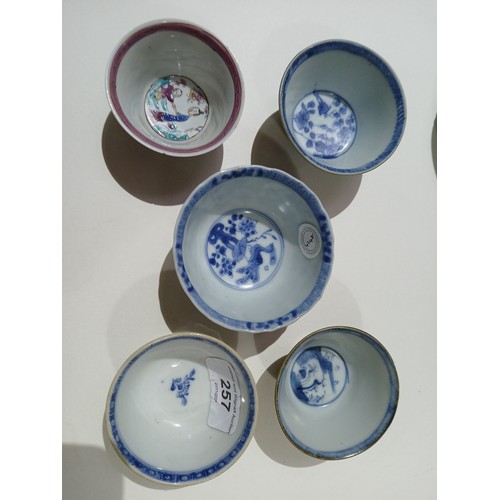 257 - A group of five Chinese porcelain tea bowls and saucers including Ca Mau ship wreck, and two others.