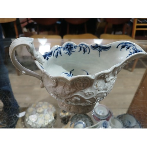 307 - An English relief moulded porcelain sauce boat, circa 1770, bluer and white decorated interior with ... 