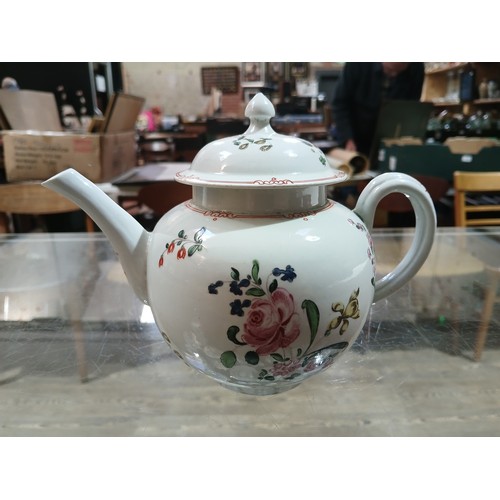 305 - A bow porcelain teapot circa 1760, decorated in floral over enamels, length 19cm.