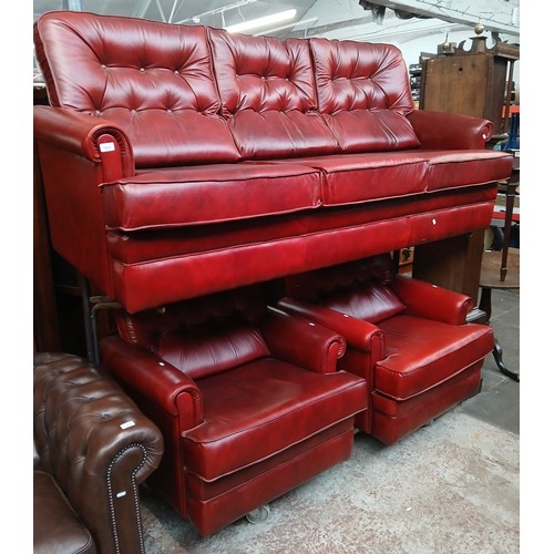 1030 - A three piece red leather suite.