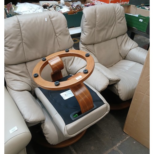 1032 - A pair of Ekorness Stressless cream leather swivel lounge chairs with one stool.