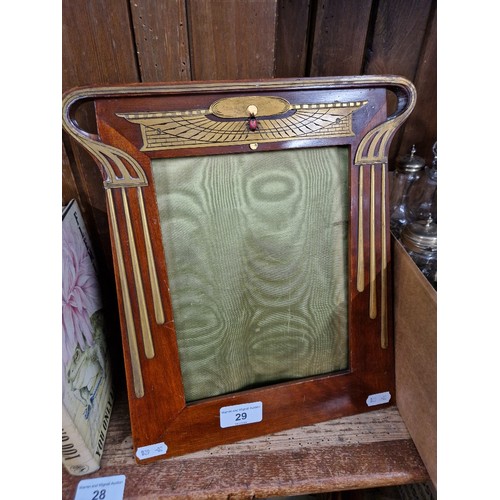 29 - An early 20th century Art Nouveau mahogany and gilt metal picture frame with Egyptian Revival detail... 