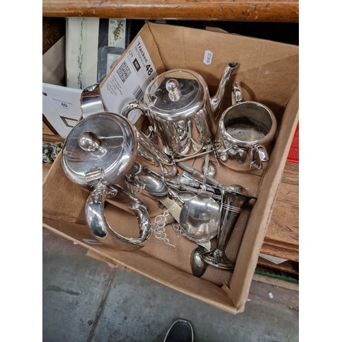 39 - A box of silver plated ware including tea pot, coffee pot, spoons, etc.