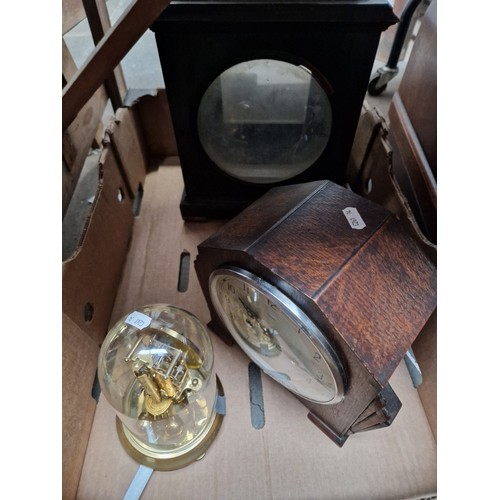 87 - A Georgian bracket clock case, an art deco mantle clock and a revolving pendulum clock.