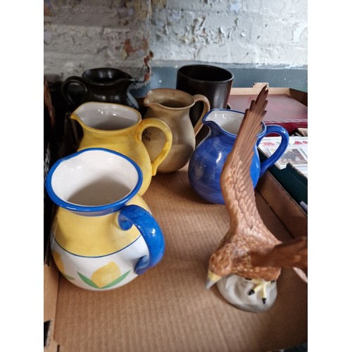 136 - A box of assorted ceramics to include a Beswick eagle & 5 jugs etc.