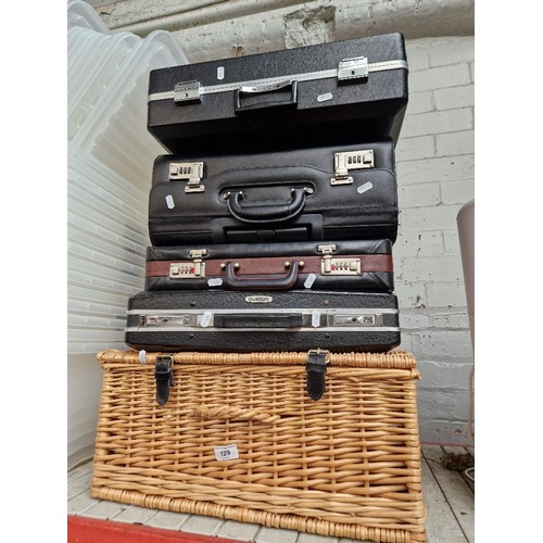 129 - Four vintage cases and a wicker picnic basket.