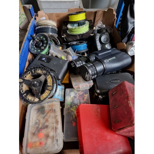 138 - A box of approx 10fly fishing reels, flies, night vision binoculars and a spotting scope