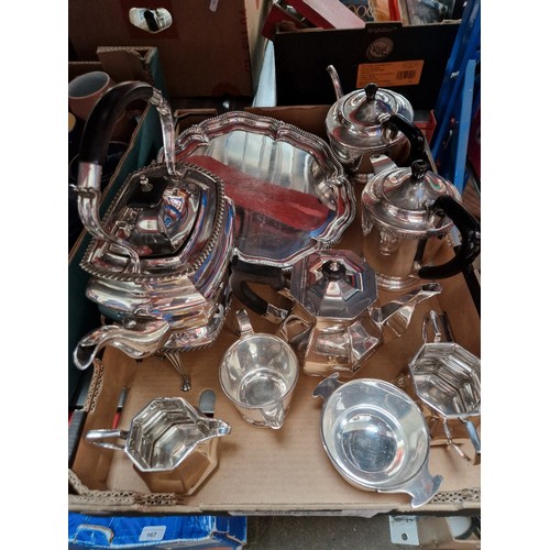 162 - A box of silver plated ware, Walker & Hall spirit kettle, three piece tea set, four piece tea set wi... 