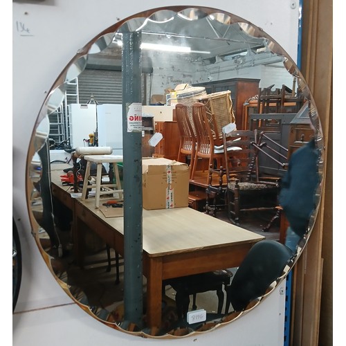 819G - A 1930s circular scallop edged wall mirror, diameter 60.5cm.