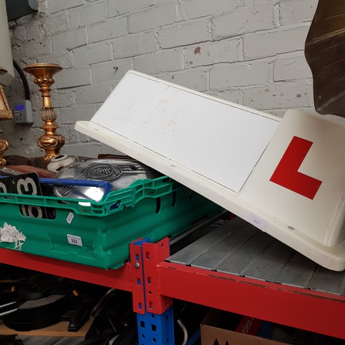 223 - A box of vintage auto parts including Ford lens, Triumph Villiers cover, magnetic L sign, lights, et... 