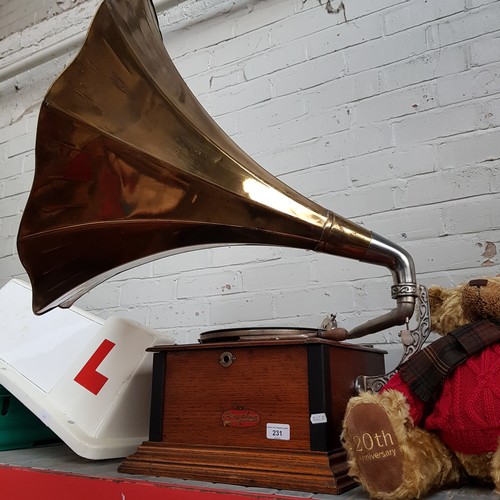 231 - A Junophone oak cased gramophone with brass trumpet.