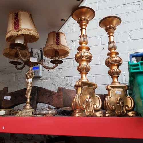 232 - A three branch brass table lamp, two gilt candlesticks and a set of brass bellows.