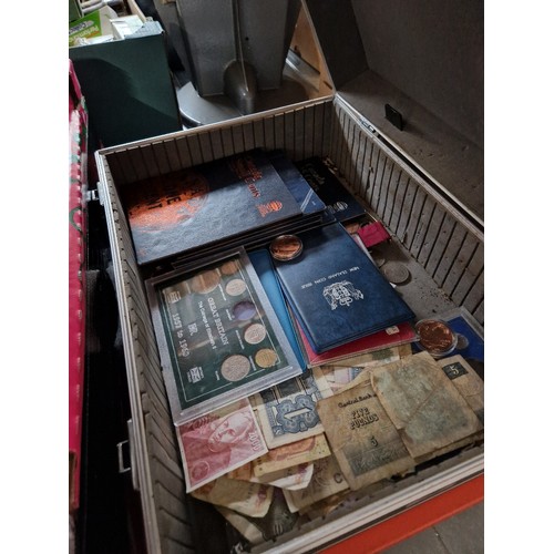 377 - A case of assorted world coins & banknotes to include sets etc.