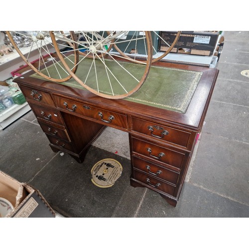 1034 - A mahogany twin pedestal desk with green leather writing surface.