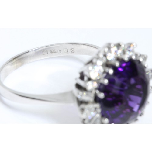 1 - AN 18CT WHITE GOLD AMETHYST AND VARI-CUT DIAMOND CLUSTER RING, the central round mixed cut amethyst ... 