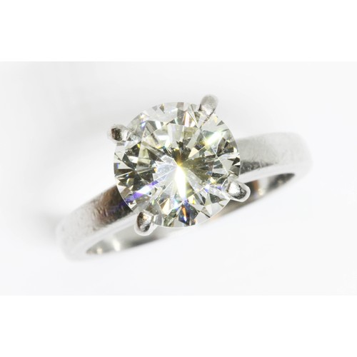 4 - A DIAMOND SOLITAIRE RING, the four claw set round brilliant cut stone weighing approximately 3cts, h... 