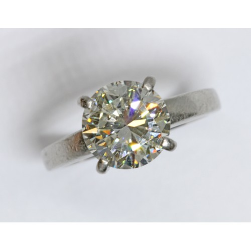 4 - A DIAMOND SOLITAIRE RING, the four claw set round brilliant cut stone weighing approximately 3cts, h... 