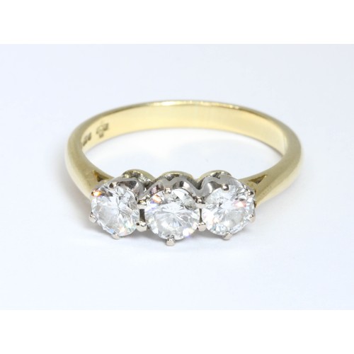 6 - A three stone diamond trilogy ring, the three round brilliant cut stones weighing approximately 0.96... 