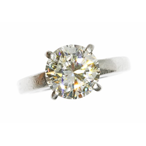 4 - A DIAMOND SOLITAIRE RING, the four claw set round brilliant cut stone weighing approximately 3cts, h... 