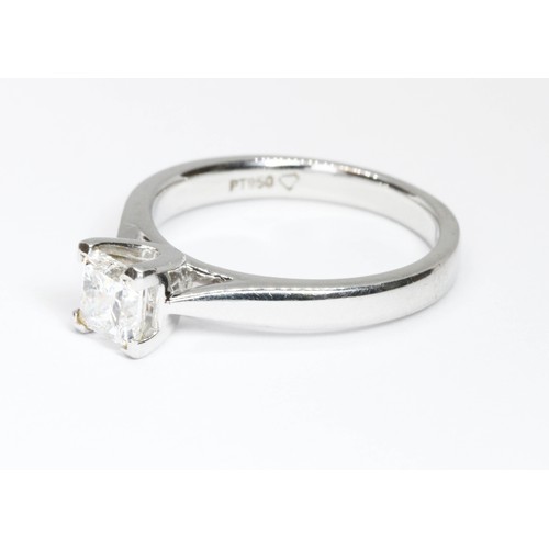 11 - A PRINCESS CUT DIAMOND SOLITAIRE RING, the square modified brilliant cut stone weighing approximatel... 