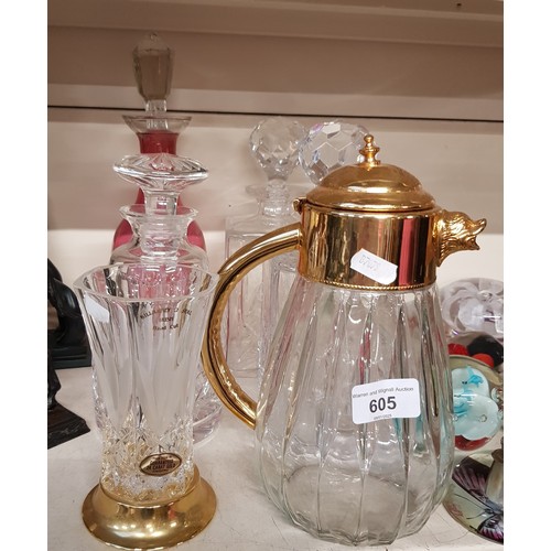 605 - Four glass decanters, claret jug and a vase