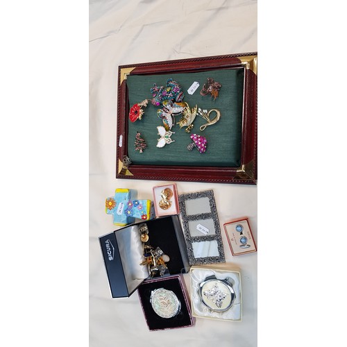 671 - A mixed lot comprising costume jewellery brooches, cufflinks, compact, etc.