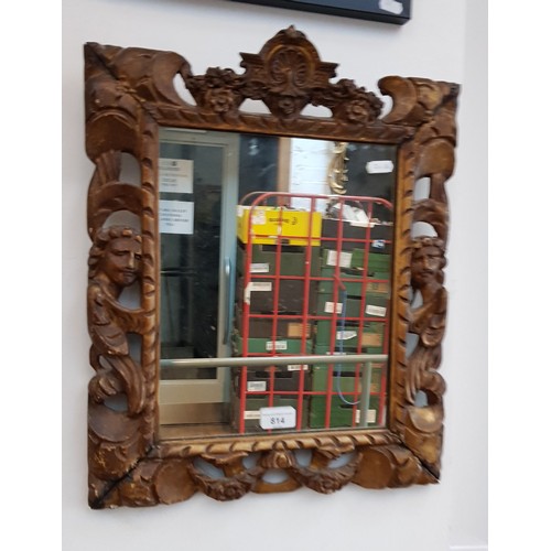 814 - A 17th/18th century carved giltwood mirror, 41cm x 50cm (overall).