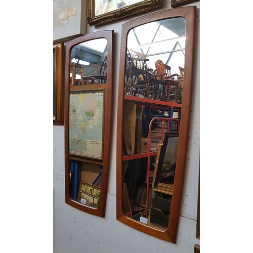 807 - A pair of mid 20th century teak framed mirrors, 38cm x 96cm each (overall).