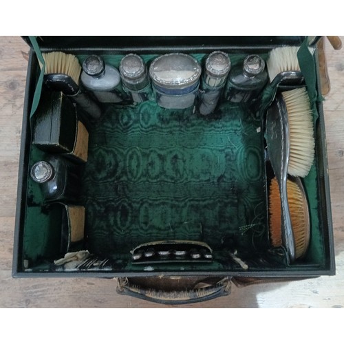 184 - MAPPIN & WEBB, an Edwardian leather travel case fitted with silver mounted dressing table set, trave... 