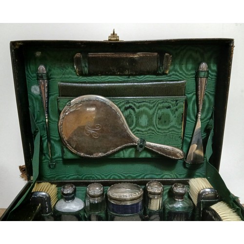 184 - MAPPIN & WEBB, an Edwardian leather travel case fitted with silver mounted dressing table set, trave... 