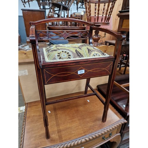 974 - An Edwardian inlaid mahogany piano stool.