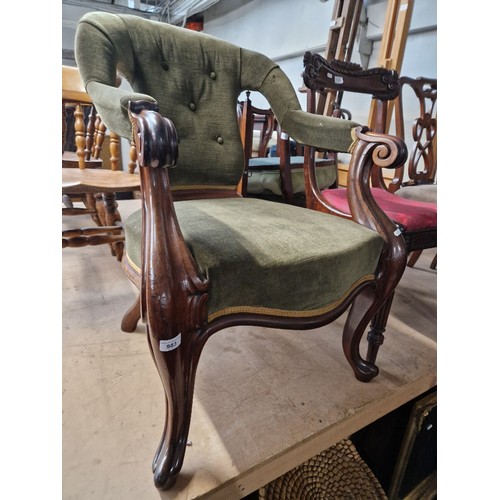 983 - A Victorian mahogany armchair with cabriole legs.