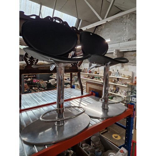 995 - A pair of aluminium and black leather kitchen/bar stools.