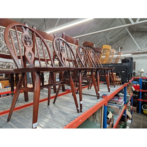 991 - A set of four Ercol dark elm 'Fleur de Lis' dining chairs.