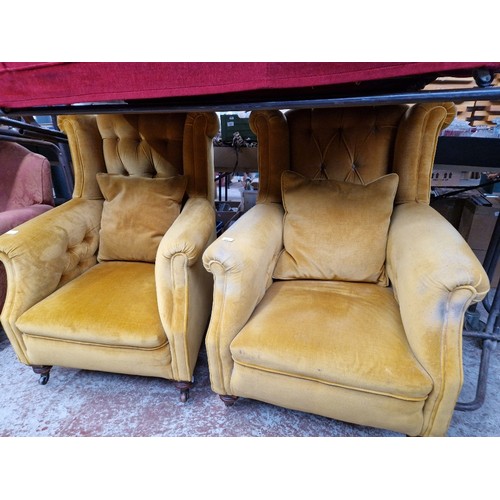 1001 - A pair of Victorian Chesterfield wingback armchairs.