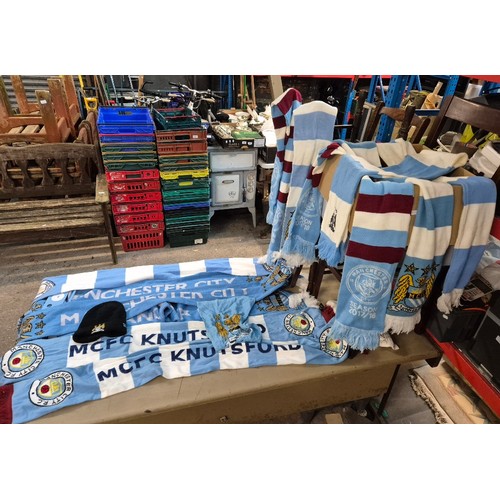 219 - A box of Manchester City Football Club shirts, tops and scarves.