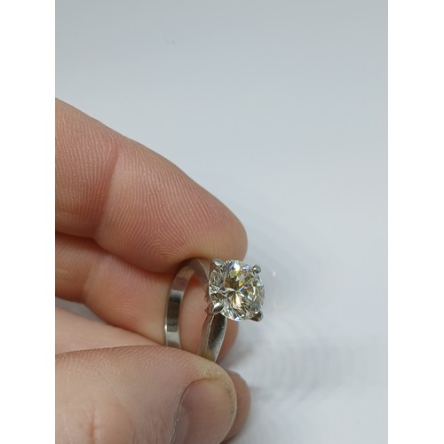 4 - A DIAMOND SOLITAIRE RING, the four claw set round brilliant cut stone weighing approximately 3cts, h... 