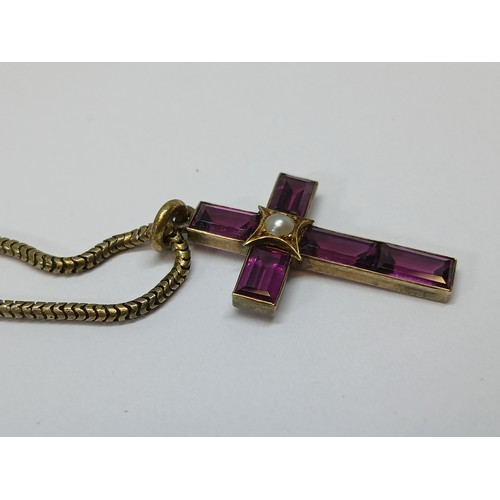 113 - A Victorian garnet and split pearl cross pendant, length 34mm, on 38cm smooth snake link chain, both... 