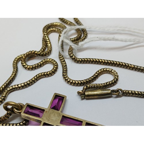 113 - A Victorian garnet and split pearl cross pendant, length 34mm, on 38cm smooth snake link chain, both... 