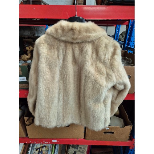 125 - Five fur coats and a faux fur including  white mink, red fox, pale mink (x2).