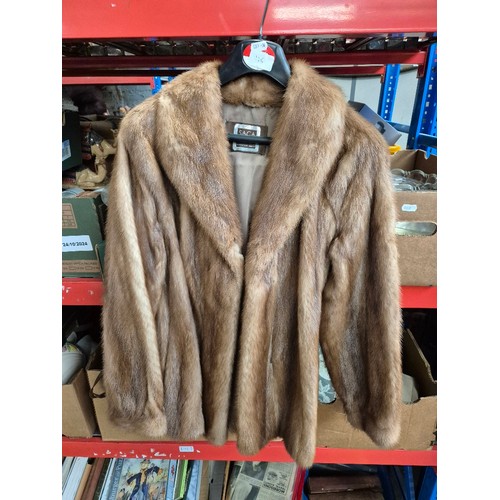 125 - Five fur coats and a faux fur including  white mink, red fox, pale mink (x2).