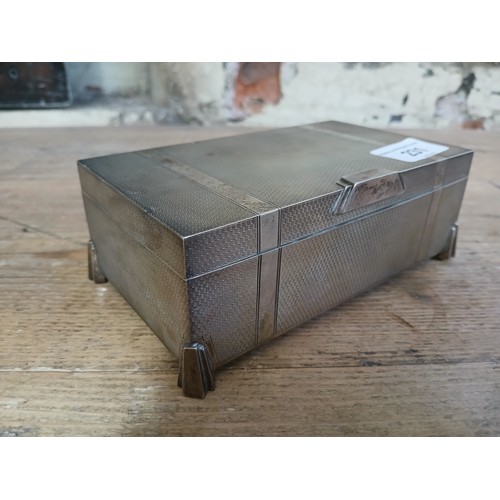 231 - An Art Deco hallmarked silver box and contents including a locket marked 9ct etc.